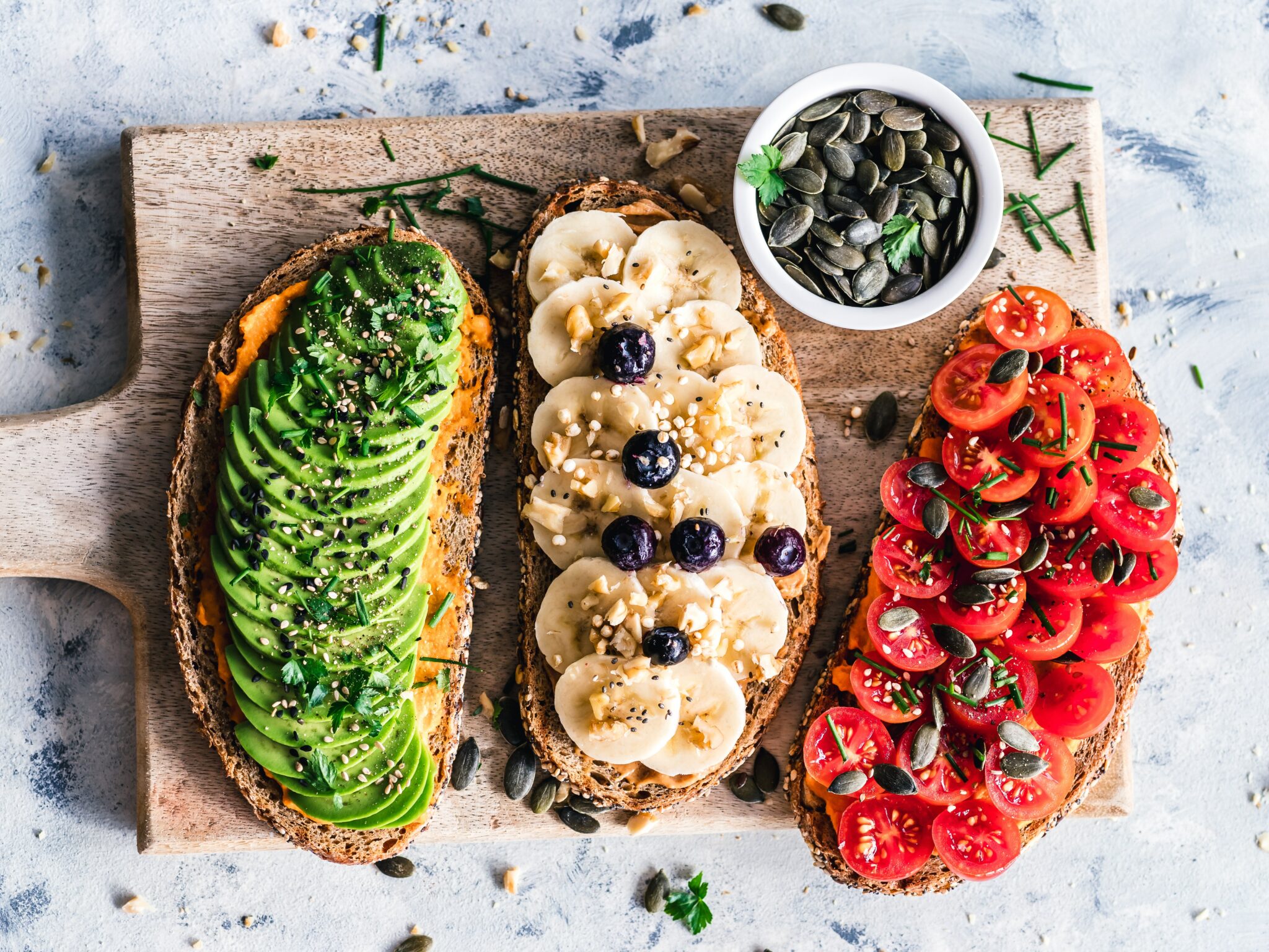 avocado, banana and tomatos on bread